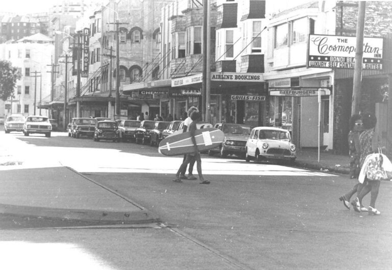 Surfers carrying coolite boards cross Cambell Parade in the 70's